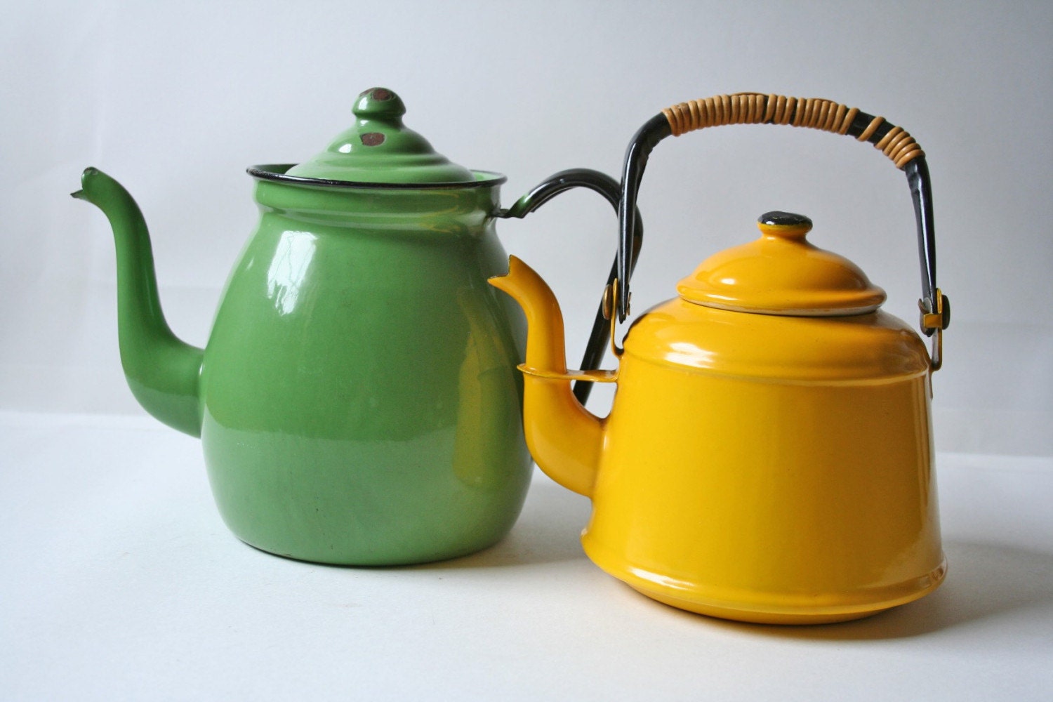 two vintage enamelware tea kettle in yellow and light green