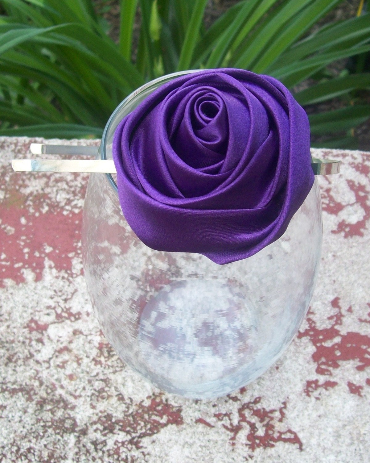 A satin purple rose headband from Etsy.