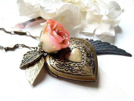 Genova. Gorgeous peach rose bud with heart shaped antiqued brass locket and angel wing and leaves necklace