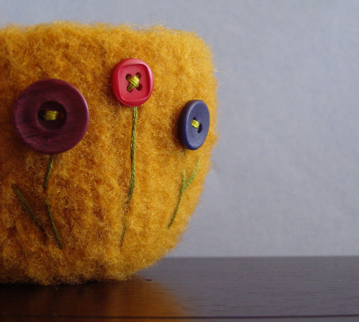 fuzzy orange gold felted wool bowl with three button flowers