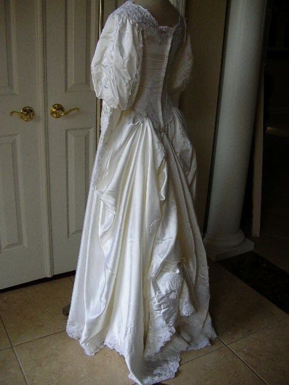 Vintage white satin wedding dress with heavily beaded and lace bodice
