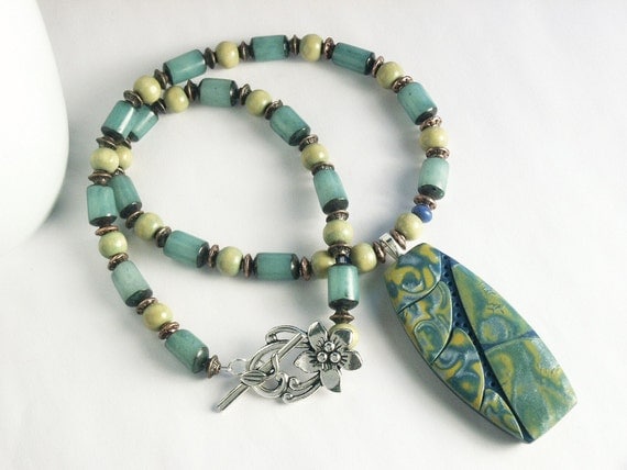Handmade Beaded Necklace featuring Polymer Clay Pendant in Tropical Leaf Design