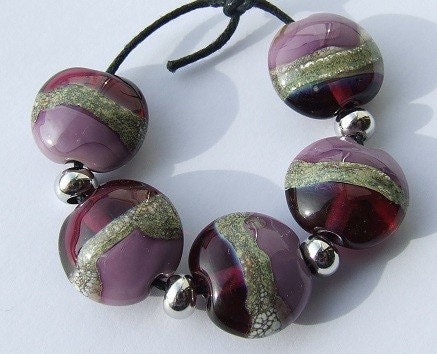 lampwork beads in luscious tones of heather and berry, with a silvered ivory detail