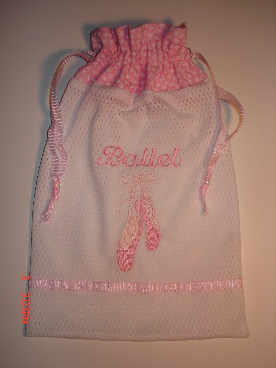 Mesh pointe/ballet dance shoe bag with embroidered pointe shoes and the word "Ballet" also embroidered on the bag