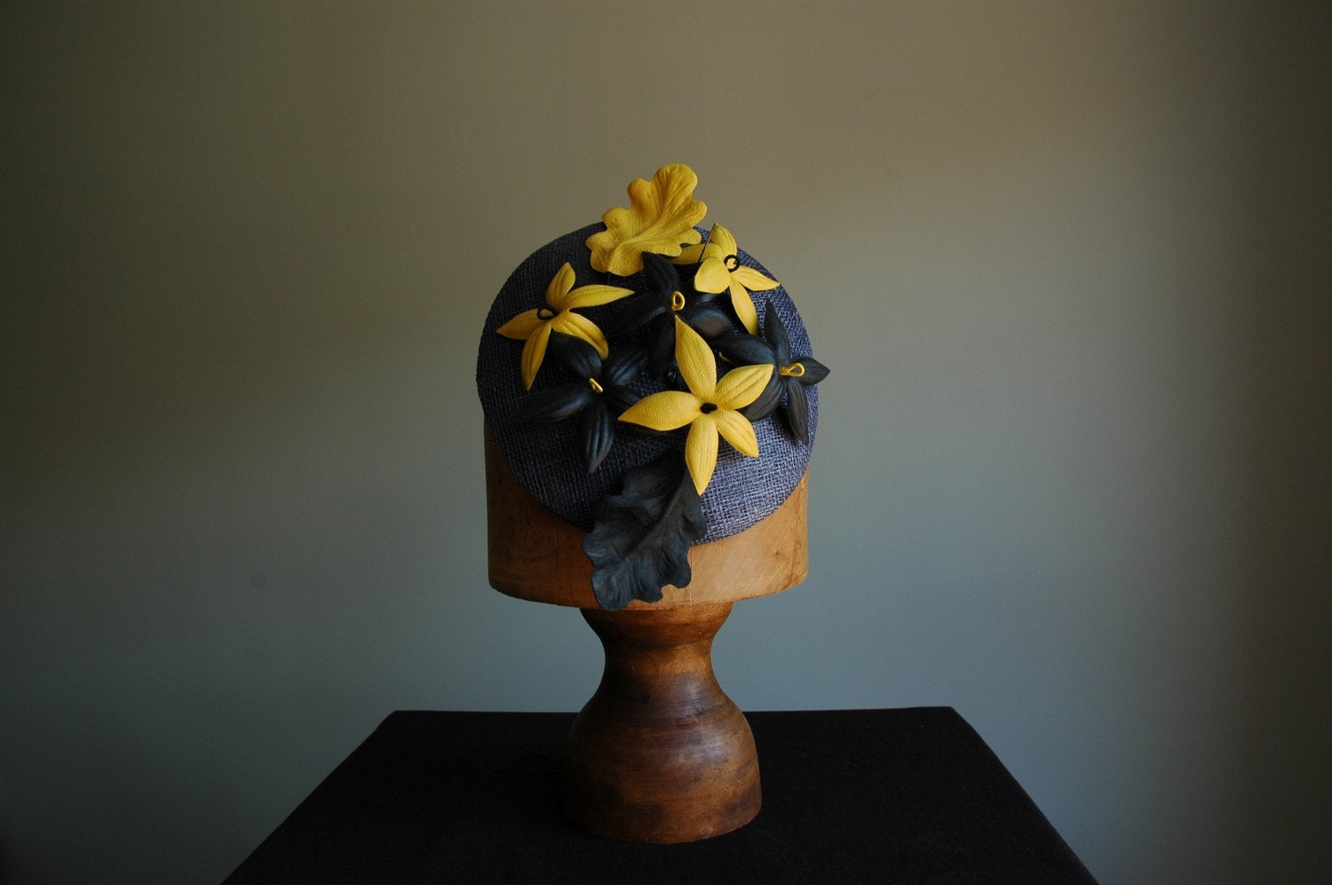 Sinamay headpiece with handmade leather flowers in black and yellow