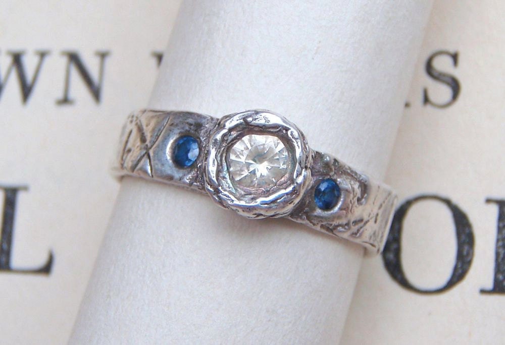 orions belt engagement ring . three fair trade sapphire gemstones . textured recycled silver band . secret inscription handwritten inside