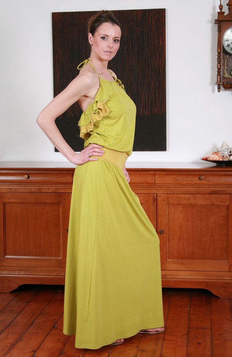 MINA Long apple green dress with yellow and green ruffles along the side seams and around the back.