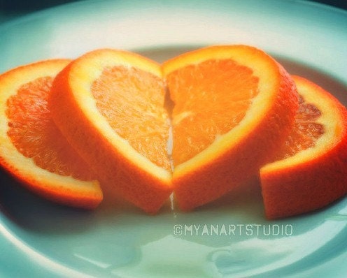 orange slices arranged like a heart on a green plate