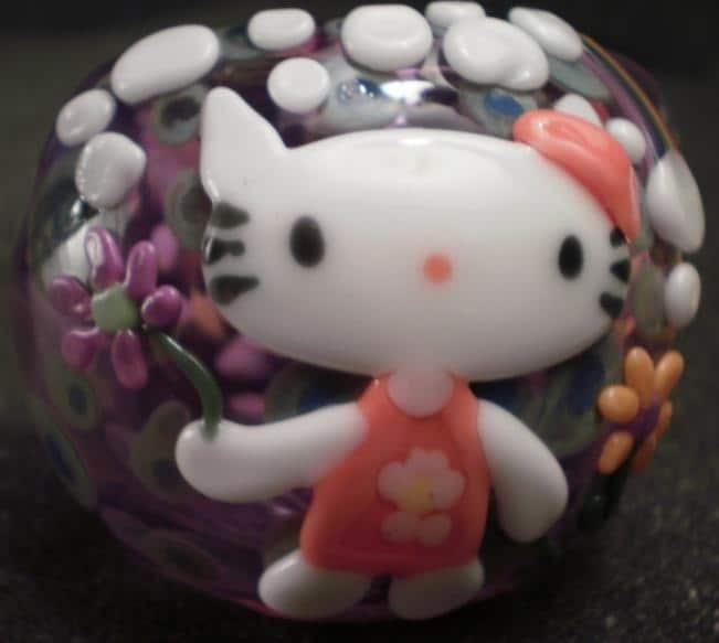 SuPeR NeW FLo HELLO KITTY with flower dress holding a purple flower and 