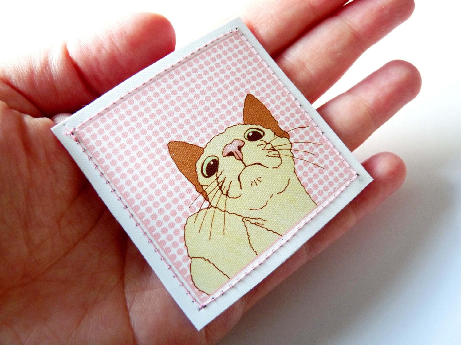 Fabric badge pin brooch featuring cat illustration
