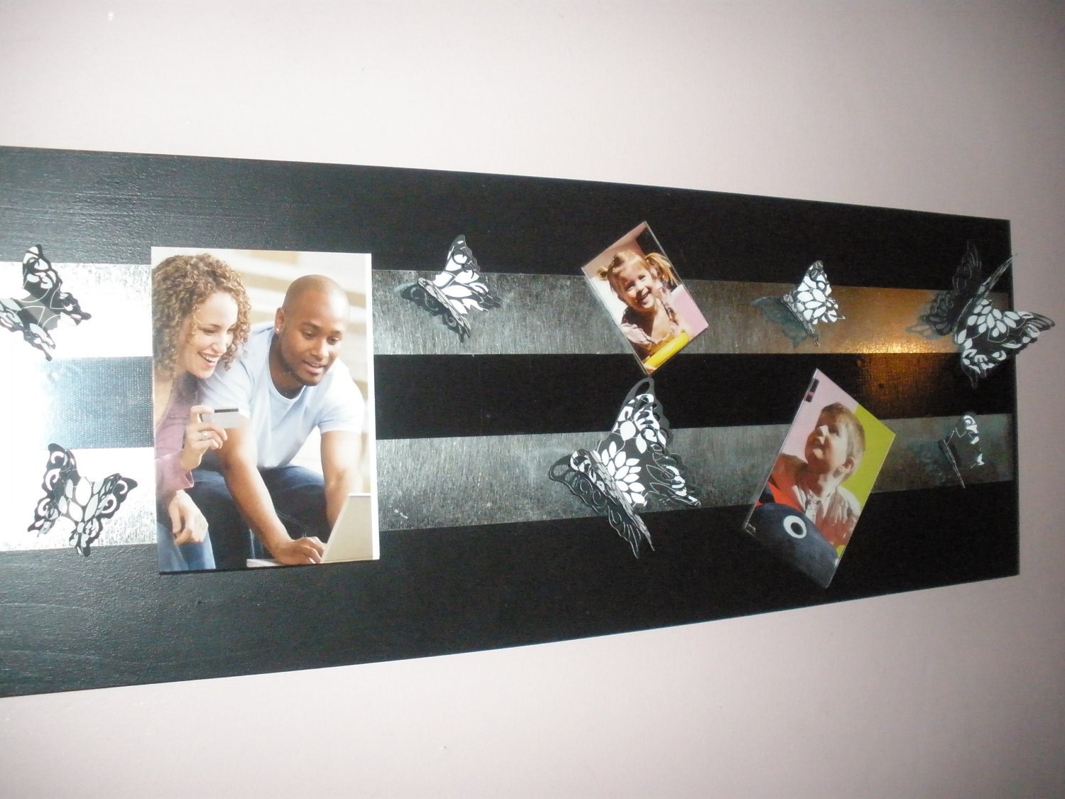Magnetic Picture Frames Displayed on a Unique Artistic Wall Board w/ Decorative Black & White Butterflies